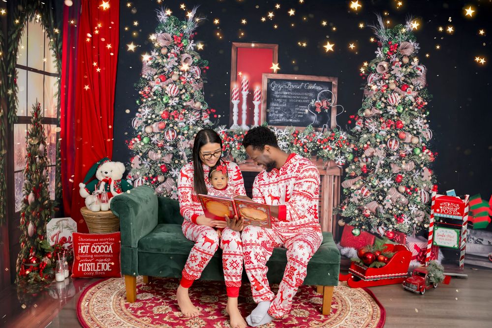 Festive Christmas display with decorated trees, red and white decor, wrapped presents, and twinkling lights in retail setting.