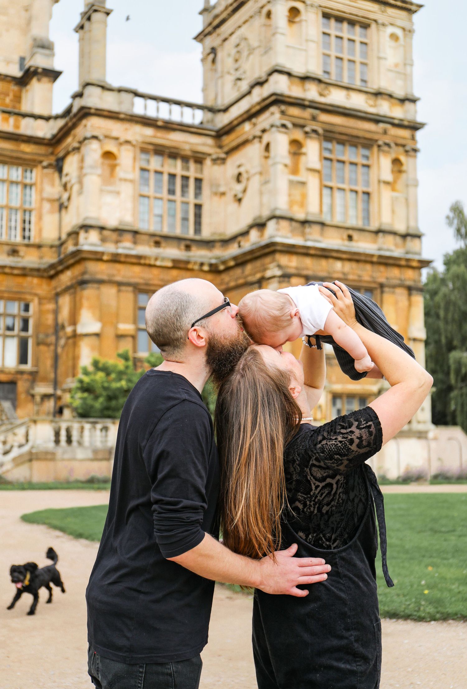 Family captured against the grand architecture during family shoot in Nottingham