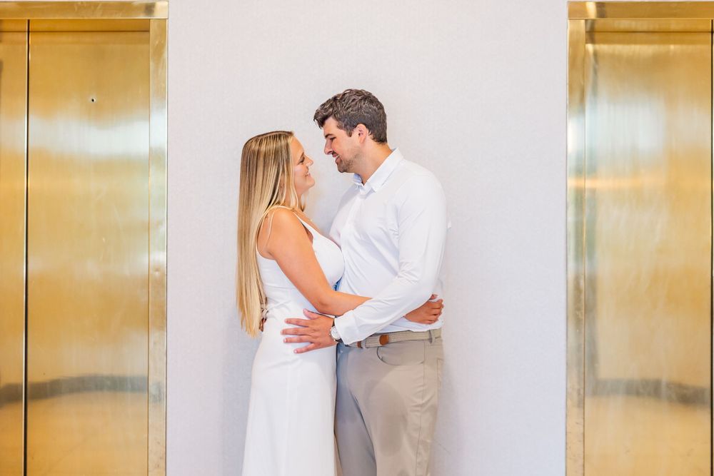 Series of photos showing couple in white outfits sharing intimate moments by gold elevator doors.