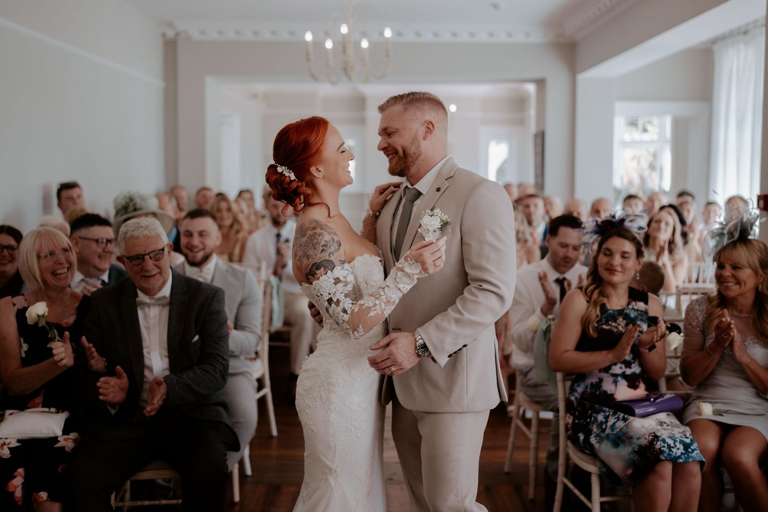 Historic brick barn venue with diamond pattern brickwork and guests gathered outside at oak farm near Ledbury, England.