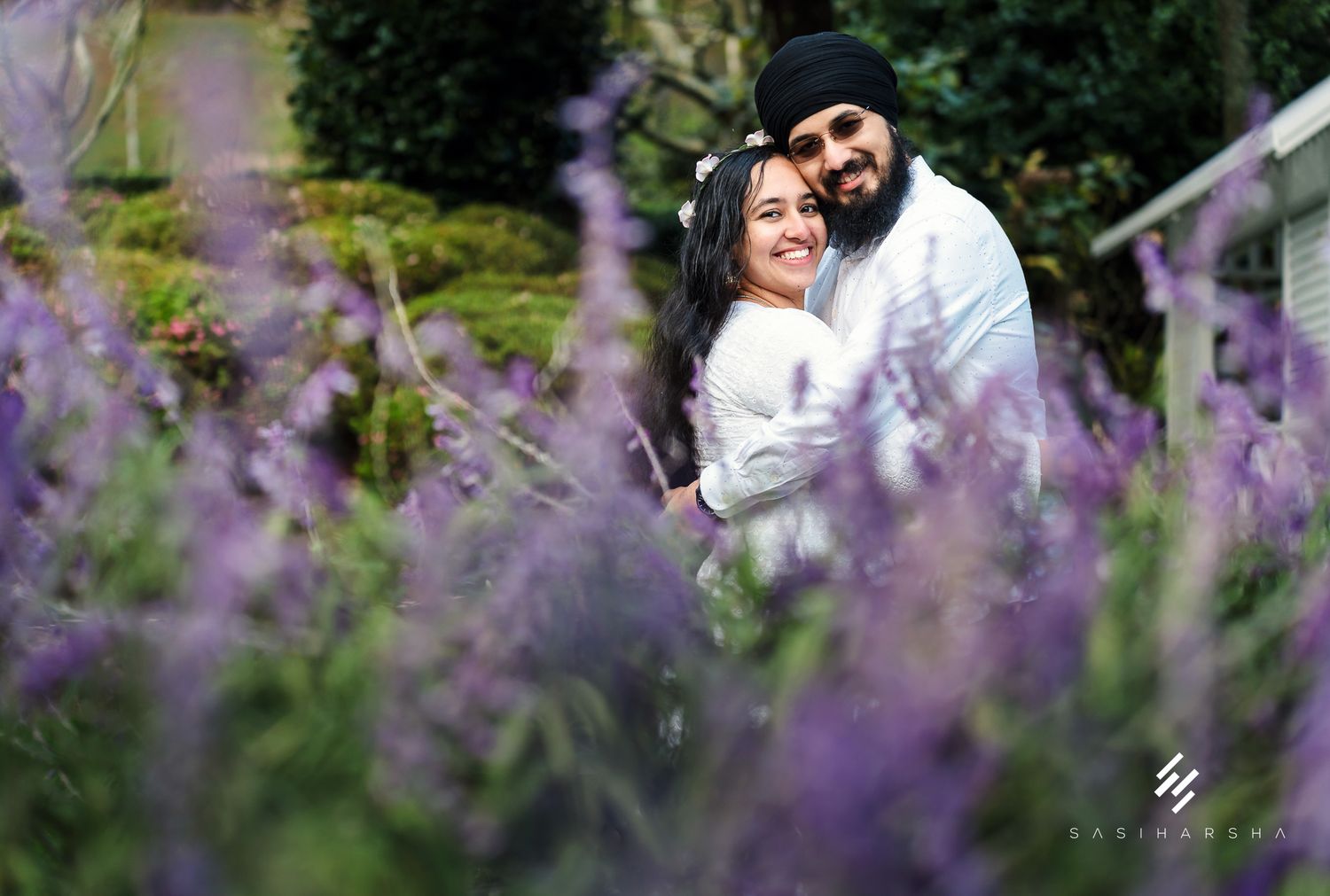 A romantic portrait through blooming purple lavender flowers in a garden setting.