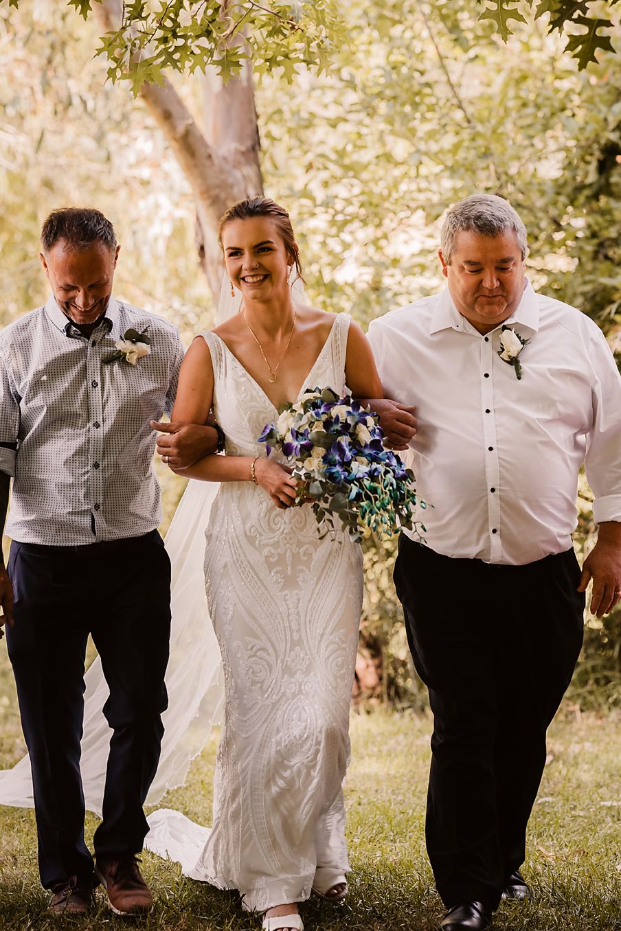 Delightful candid sequence of a wedding party outdoors joking and walking together as they pose for creative photos.
