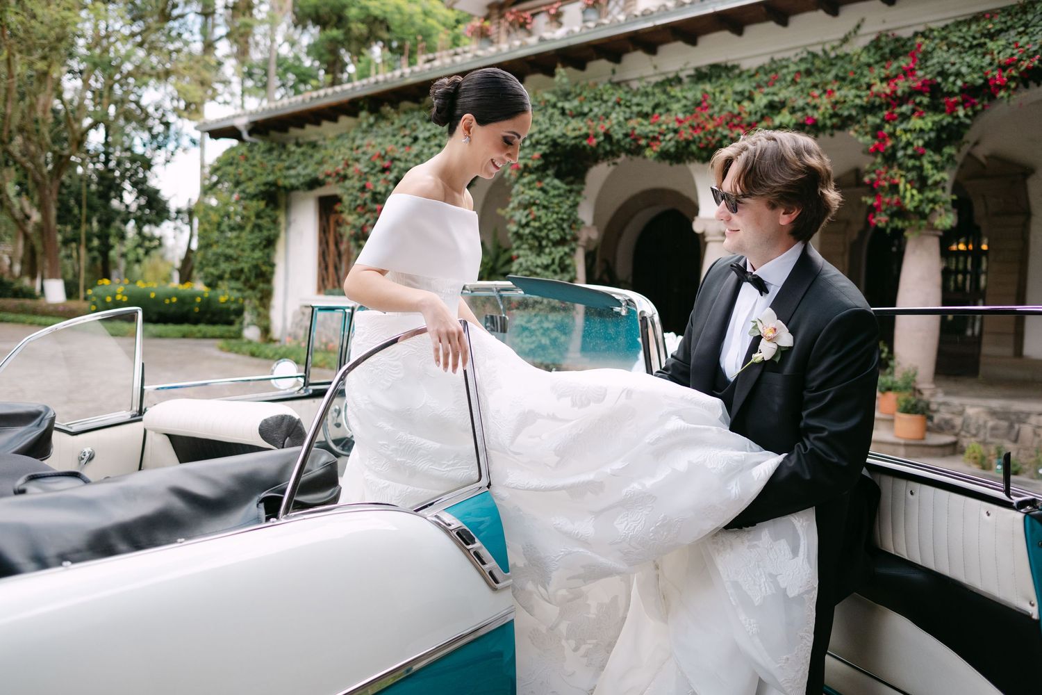 Classic teal vintage car decorated for a wedding celebration.