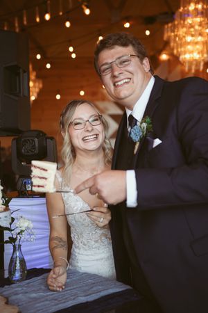 A joyful moment shared between newlyweds during their wedding reception.