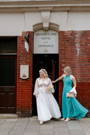 Three sequential photos of people in formal dresses twirling outside a brick building with Brewer's Inn Hotel signage.