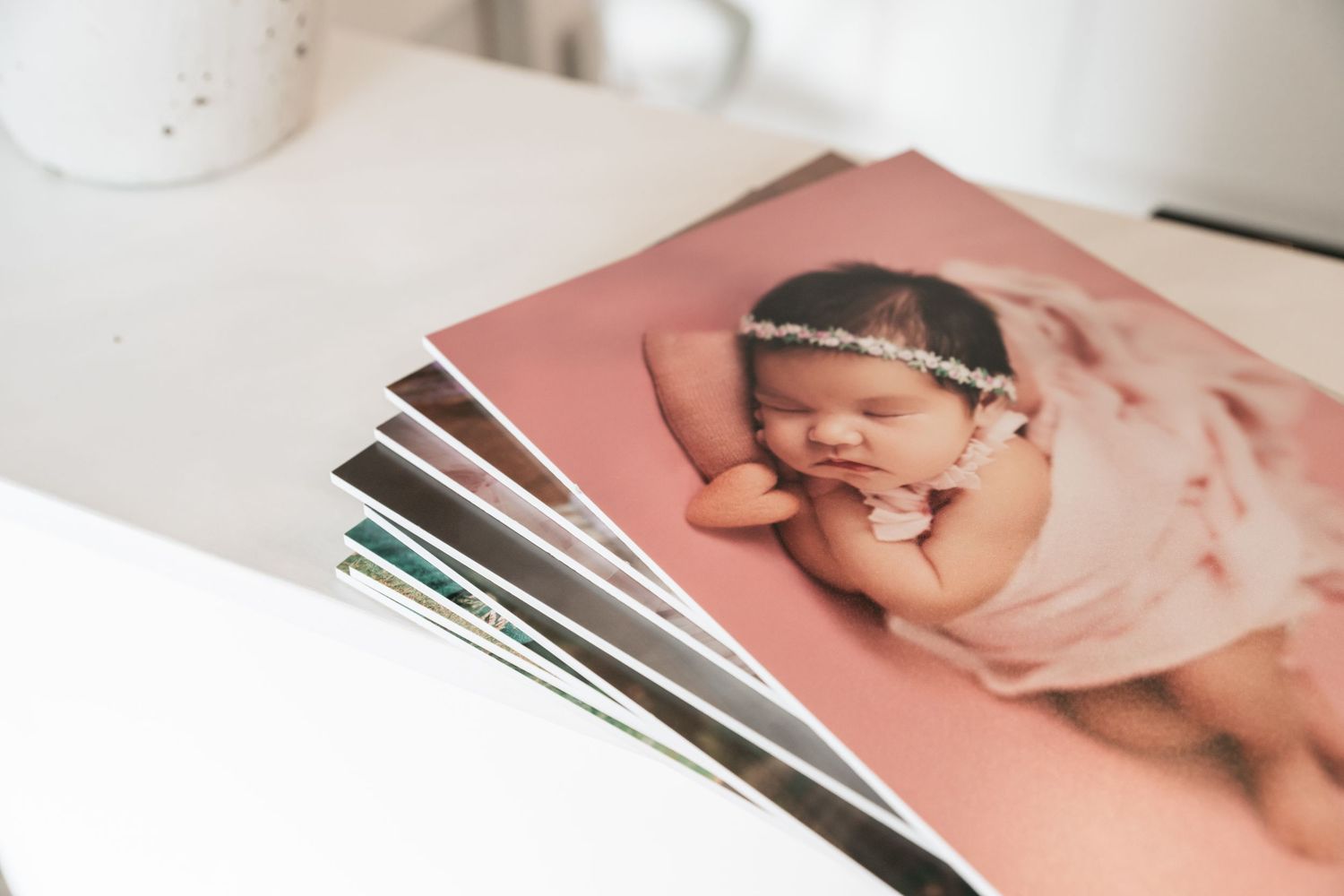 Collection of professional photo prints displayed on white surface showing matted edges.