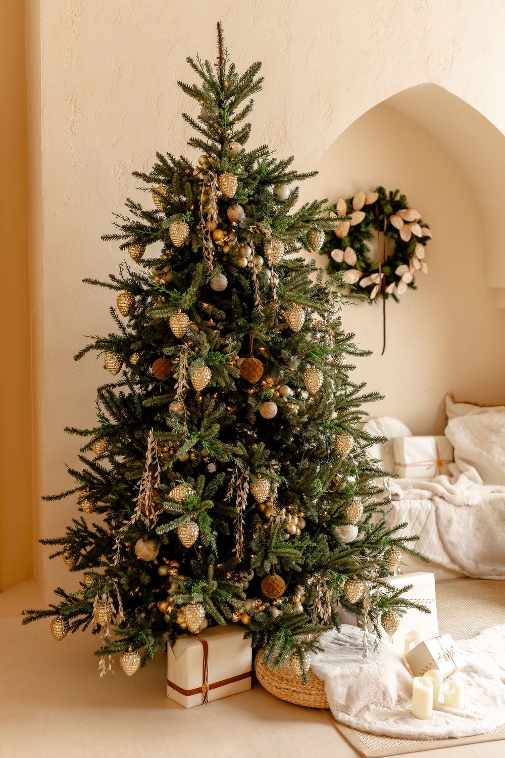 A series of four photos showing small decorated Christmas trees with white presents on a neutral background.
