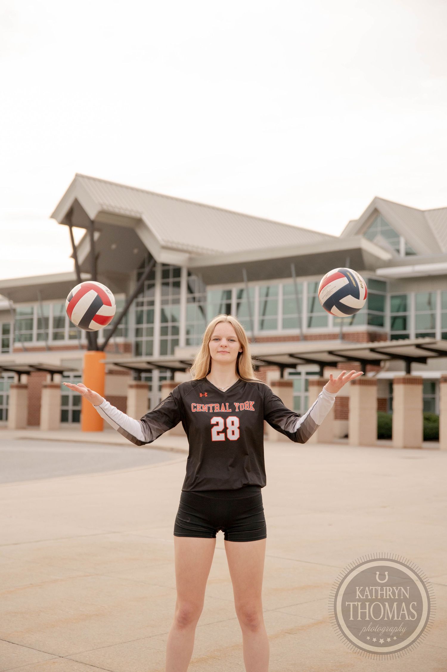 Series of volleyball themed senior portraits taken outside a school gym showing student athlete in team jersey.