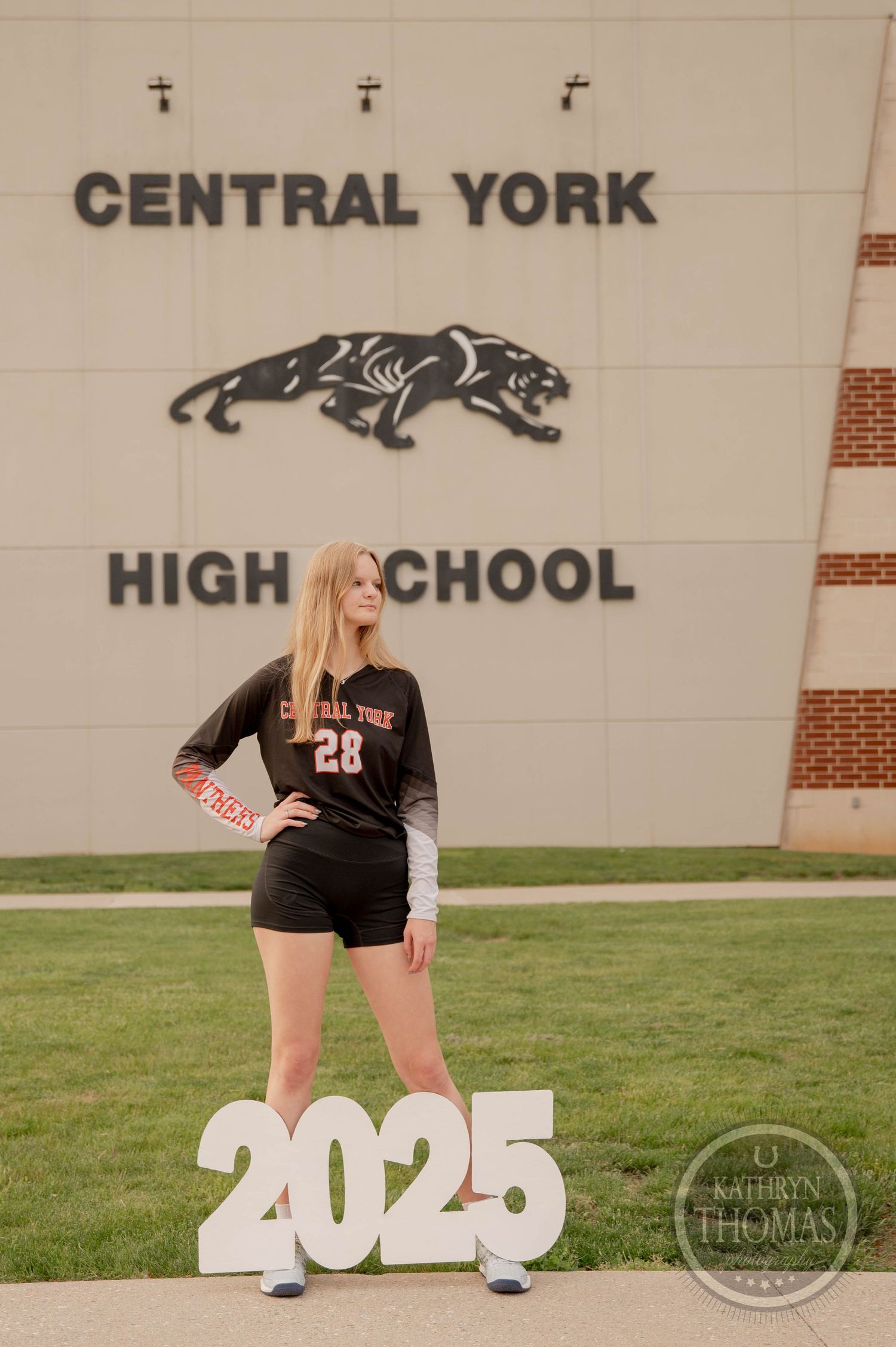 Senior portrait session at Central York High School with class year 2025 numbers displayed on grass field.