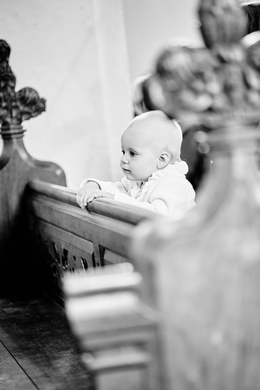 Black and white artistic photo series of a baby resting in a cradle.