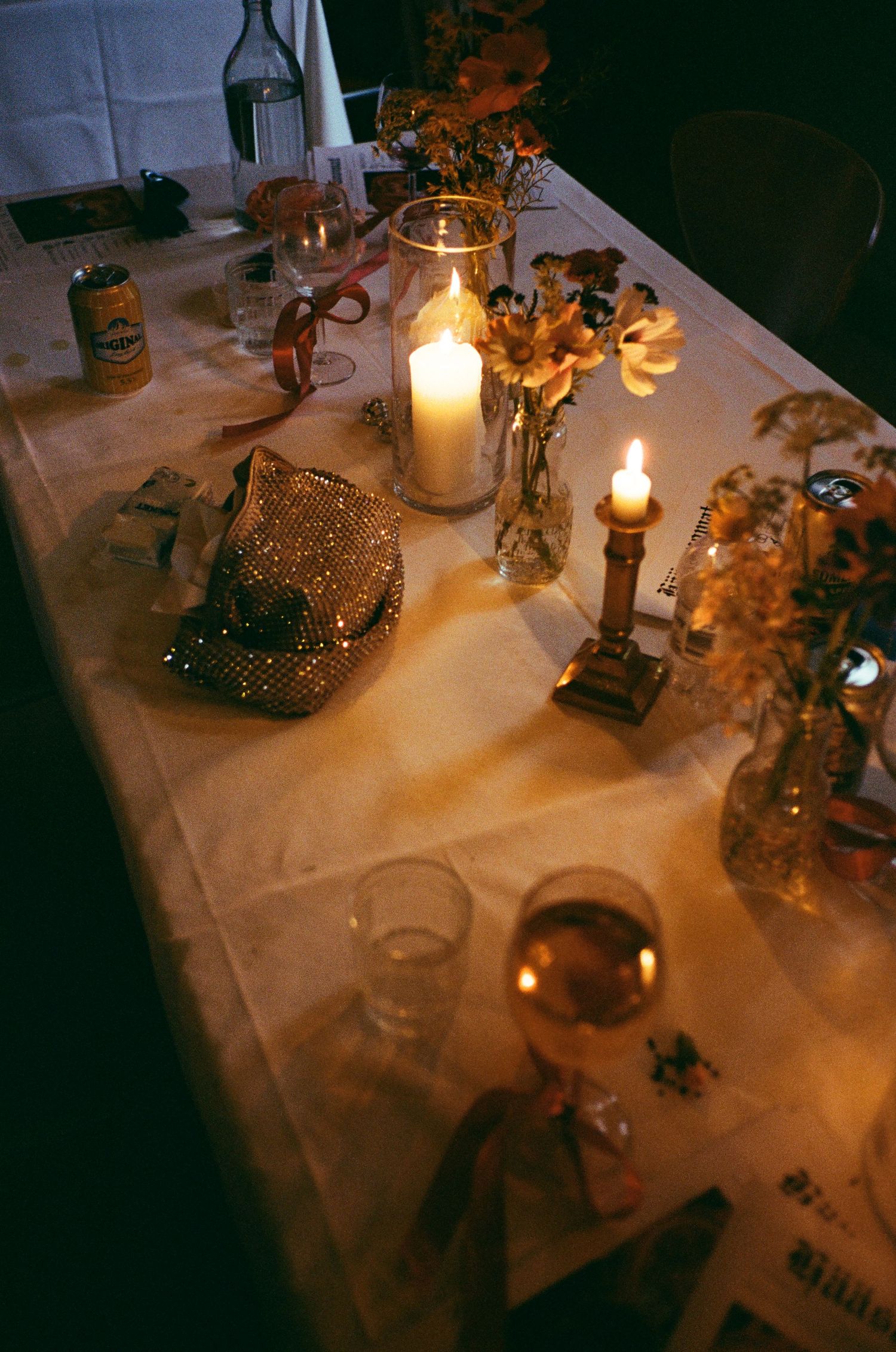 Candlelit table setting with wine glasses and decorative elements creating a romantic ambiance.