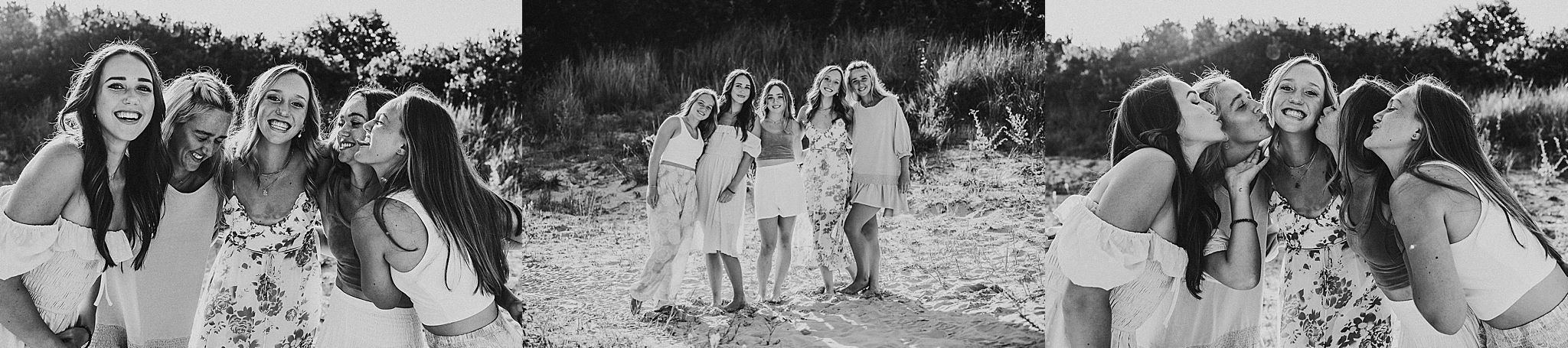A black and white panoramic photograph showing people dressed in white posing together outdoors.