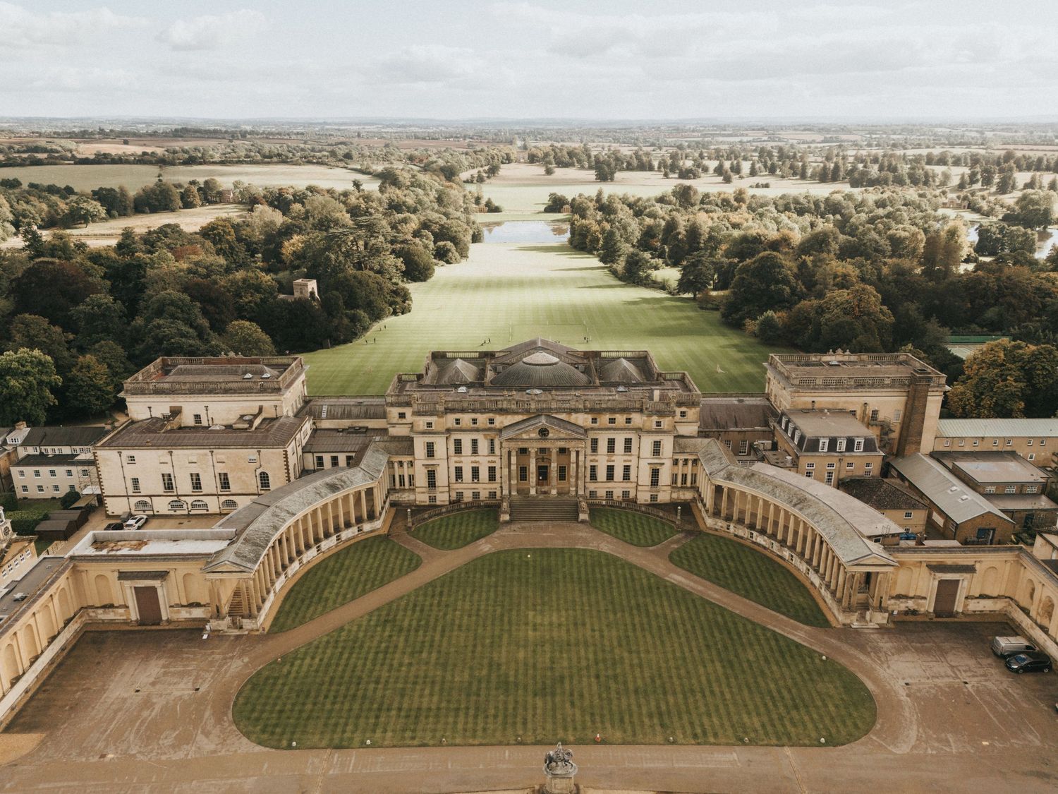 Aerial view of Stowe House mansion with its grand colonnade and manicured lawns in England.