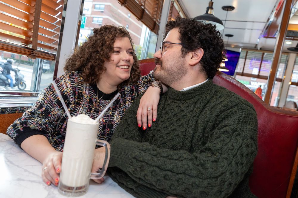 Engaged Couple sips milkshake at Bel-Aire Diner in Astoria, Queens.