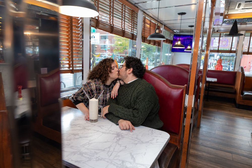 Engaged Couple sips milkshake at Bel-Aire Diner in Astoria, Queens.