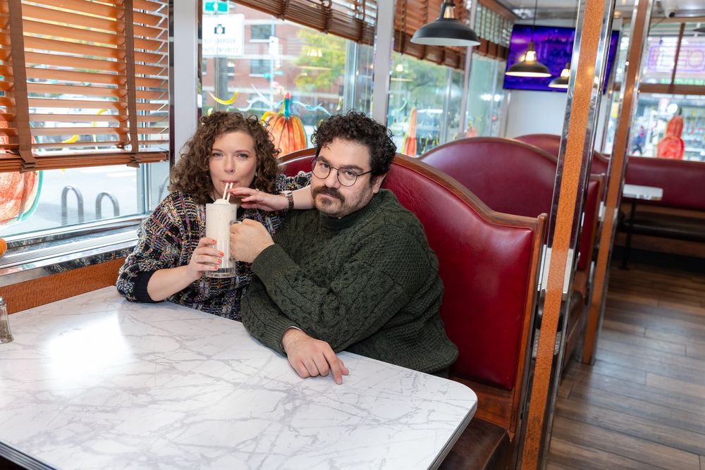Engaged Couple sips milkshake at Bel-Aire Diner in Astoria, Queens.