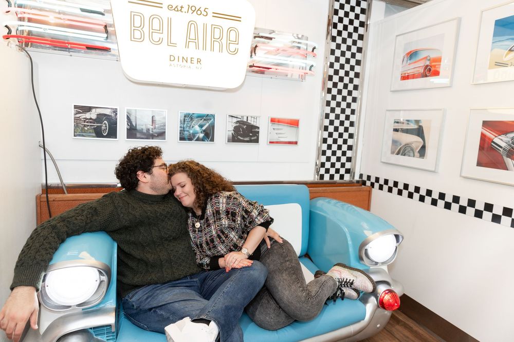 Engaged Couple relaxes during photo session at Bel-Aire Diner in Astoria, Queens.