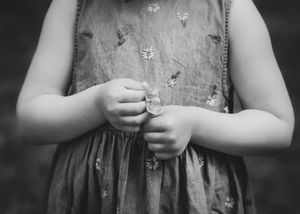 Close up of child’s hands holding flowers child detail photography, artistic family shoot