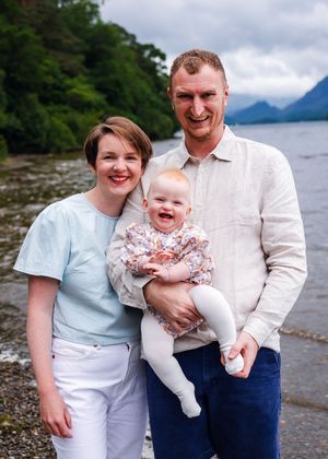 Smiling family of three by the water family photographer near you.