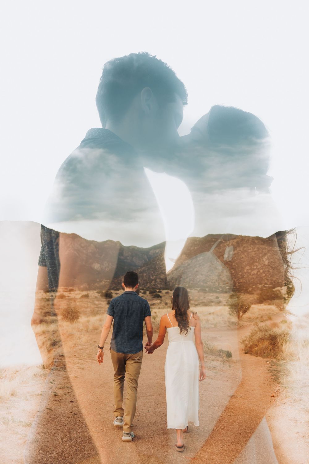 Multiple exposure silhouettes walking across desert terrain with soft hazy overlay effect.