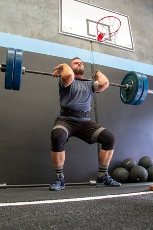 Sequence showing barbell squat technique from a side angle in a gym setting.