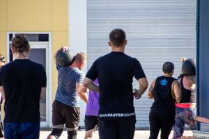 Group workout session visible through an industrial doorway.