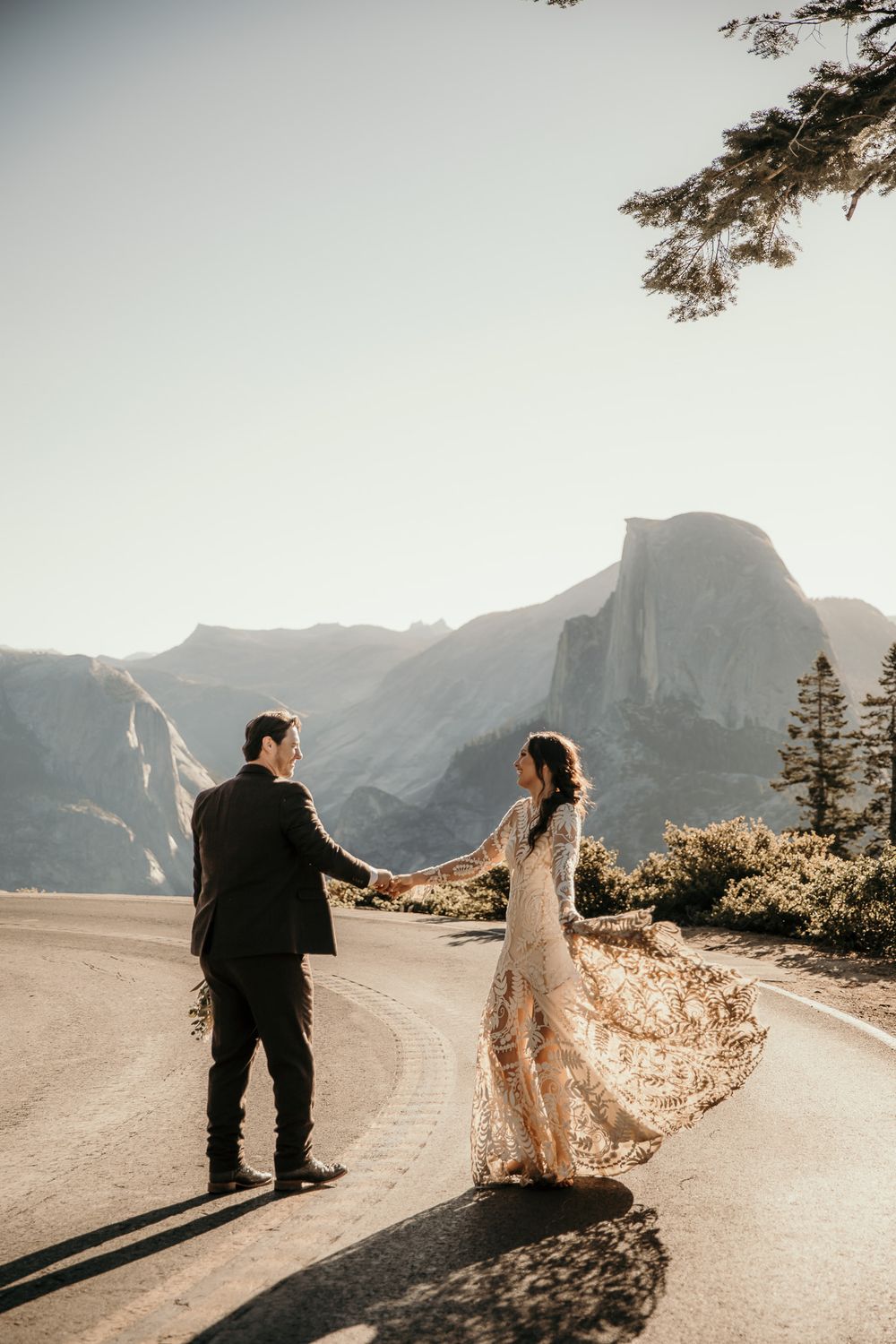 Romantic mountain road photoshoot with Half Dome visible in the background.