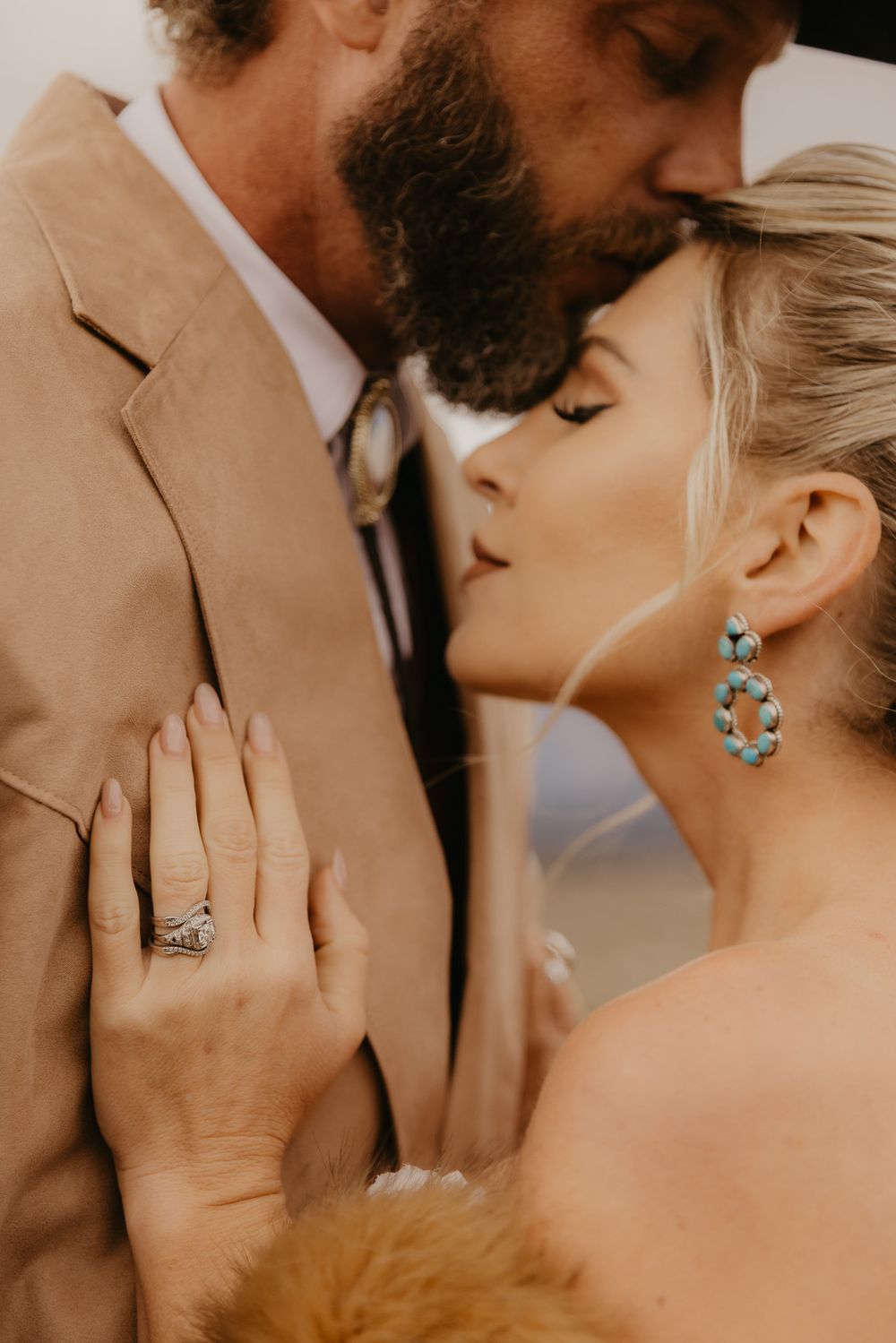 Romantic close-up photo series showing a couple kissing with turquoise earrings and engagement ring details.