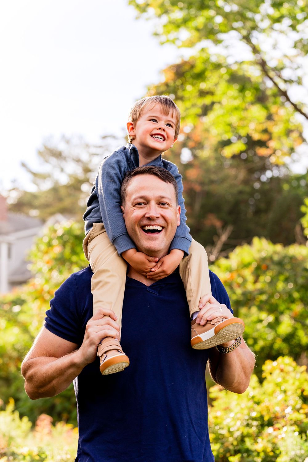 Playful sequence of piggyback rides in a sunny garden setting with natural greenery in background.