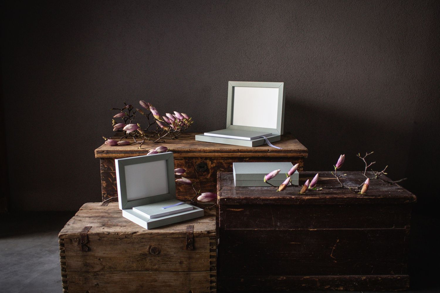 Professional photography storage boxes displayed on vintage wooden table in studio setting.