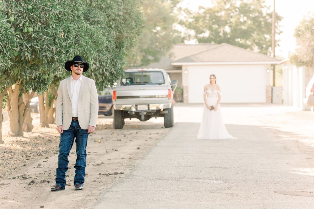 A couple shares a tender moment in a rustic outdoor setting during golden hour.