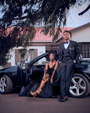 a couple standing by their car