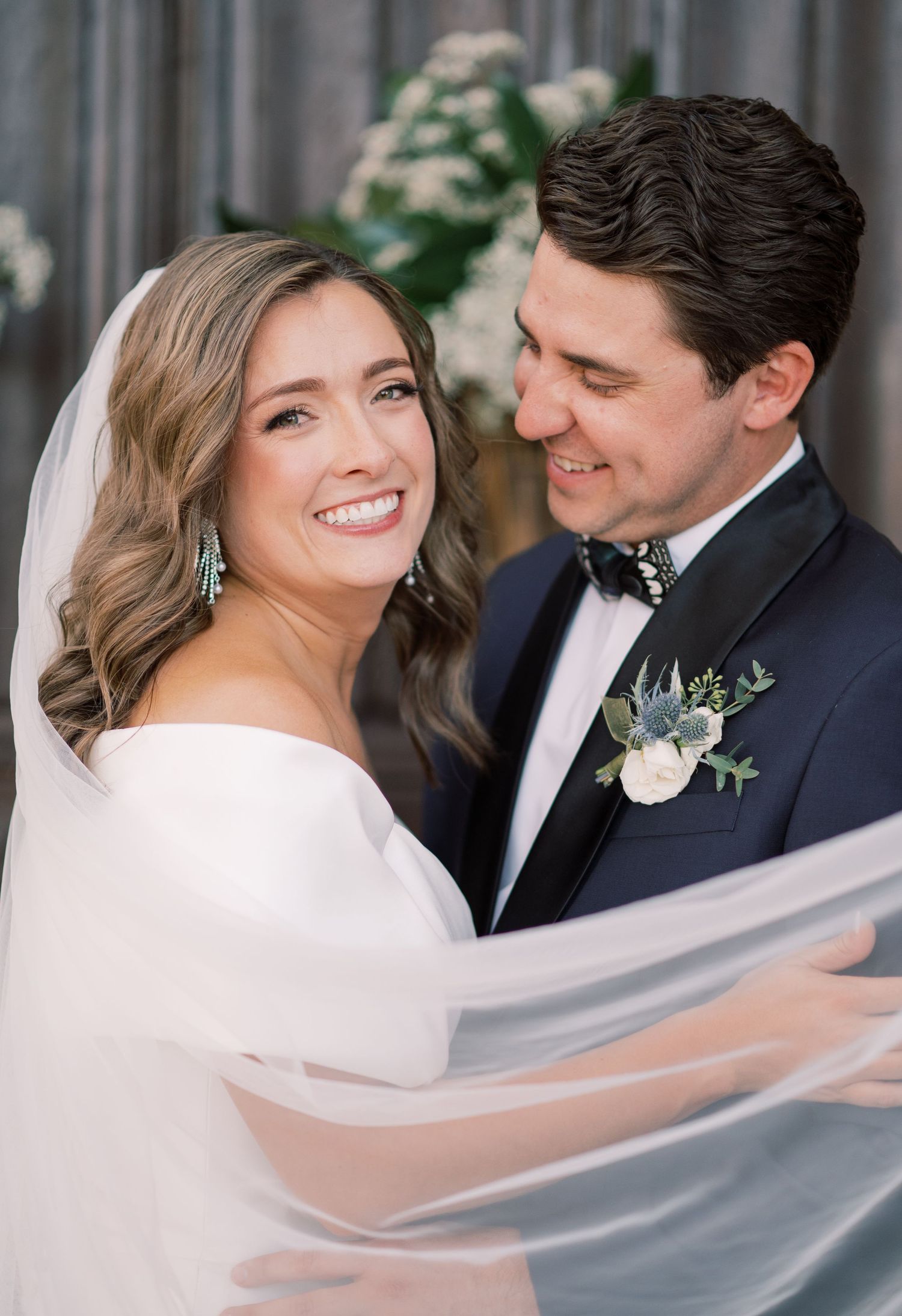 A romantic wedding portrait series showing a couple with flowing veil in elegant formal attire.