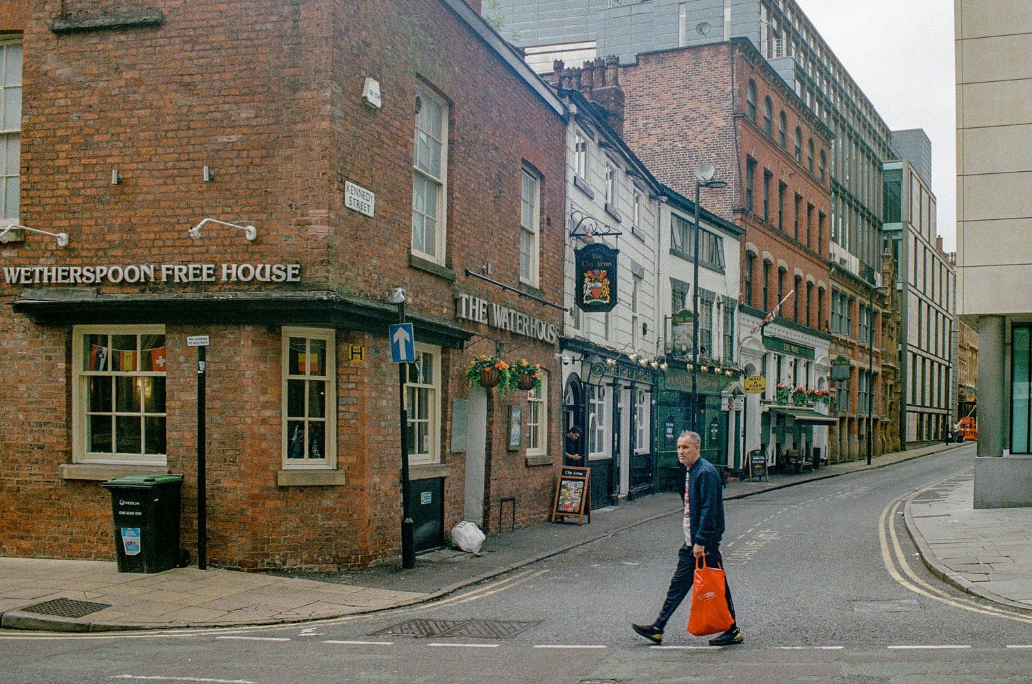 Curved street lined with traditional brick buildings in a historic district.