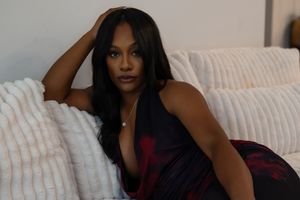 A woman in a burgundy dress poses on a white couch in a series of four candid shots.