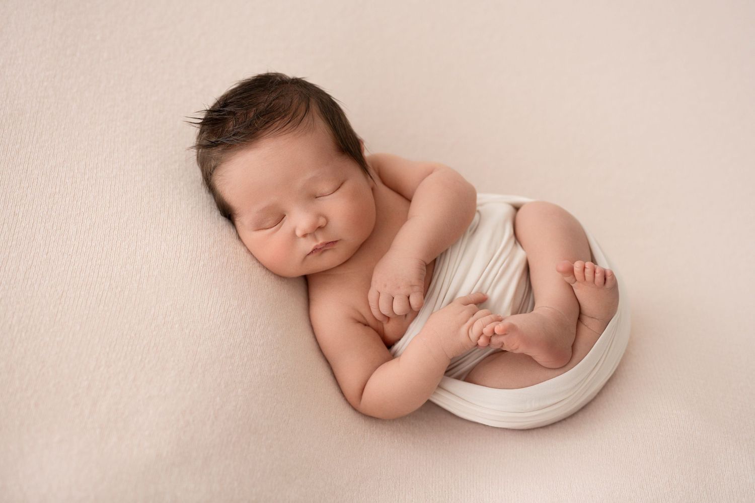 Newborn Photography Melbourne, sleeping newborn baby wrapped in a white wrap