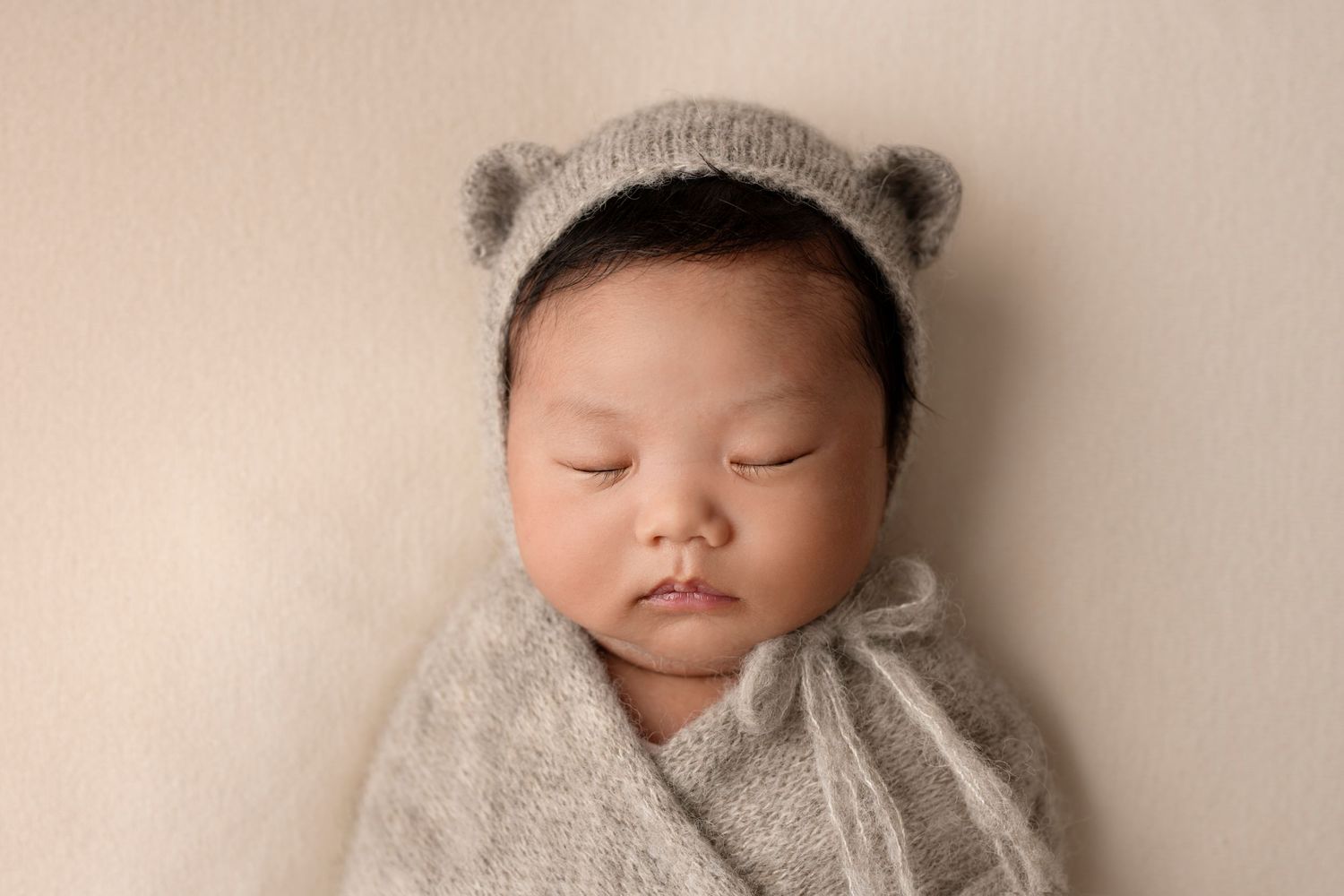 Sleeping newborn baby with a cute bear hat
