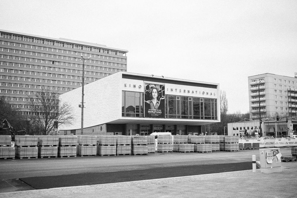 A modernist building facade with large billboard display in East Berlin architecture style.