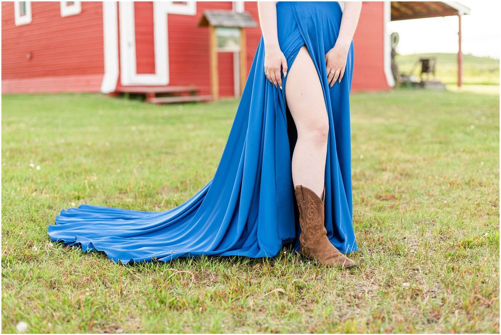 Royal blue formal dress with dramatic side slit and long flowing train on grass.