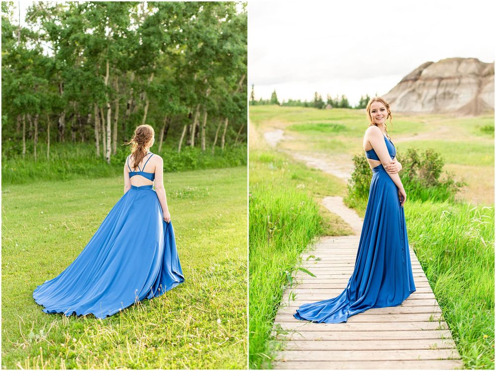 Dramatic blue dress flows in outdoor photos against natural landscape and wooden boardwalk.
