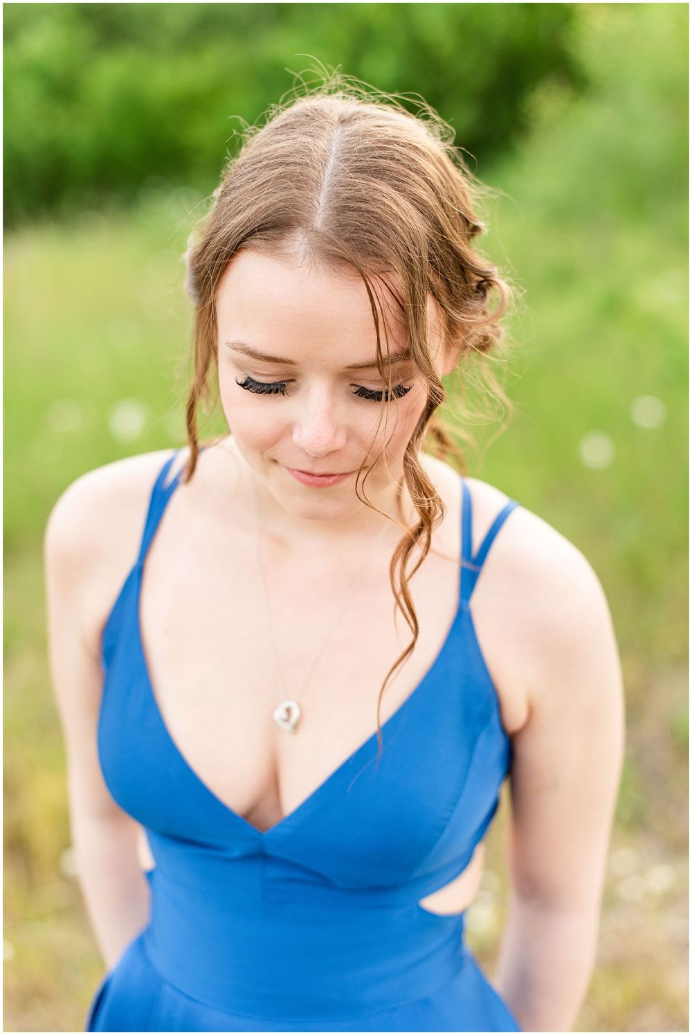 Soft close-up portrait showcasing delicate details of a royal blue formal dress.