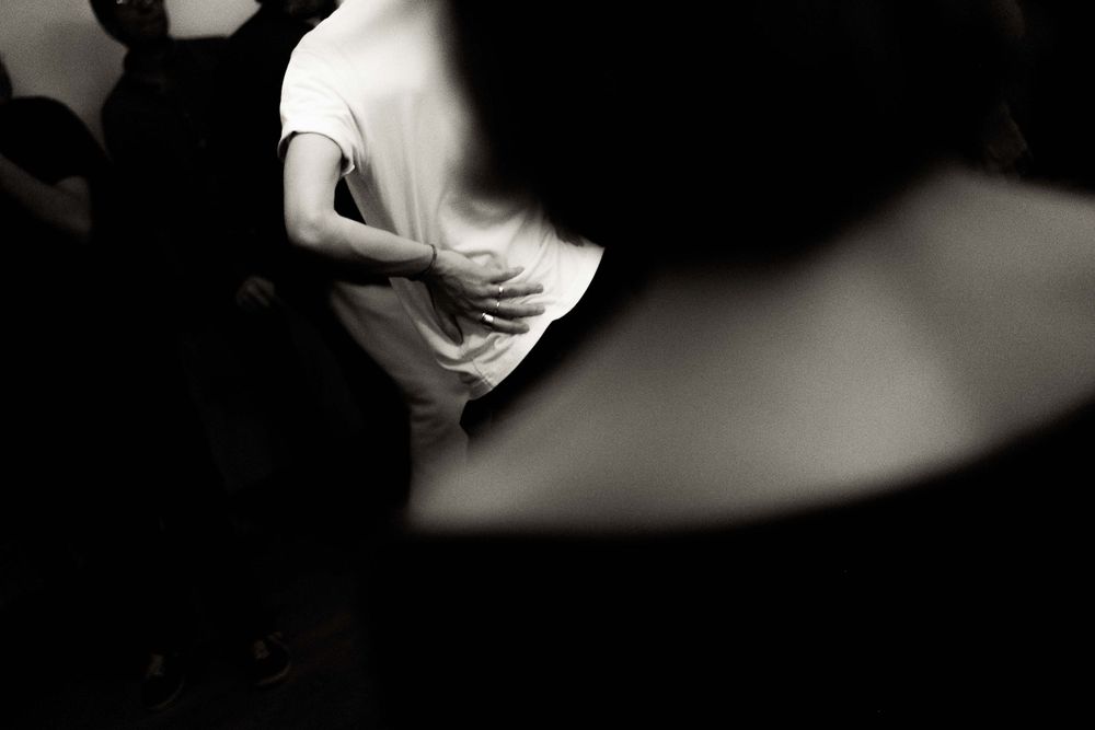 Abstract black and white photograph capturing movement and dance.