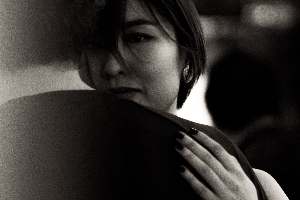 Atmospheric black and white portrait in intimate lighting.