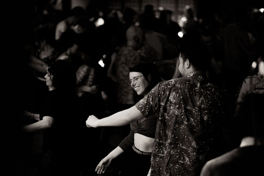 Black and white photo of people dancing at a crowded nightclub.