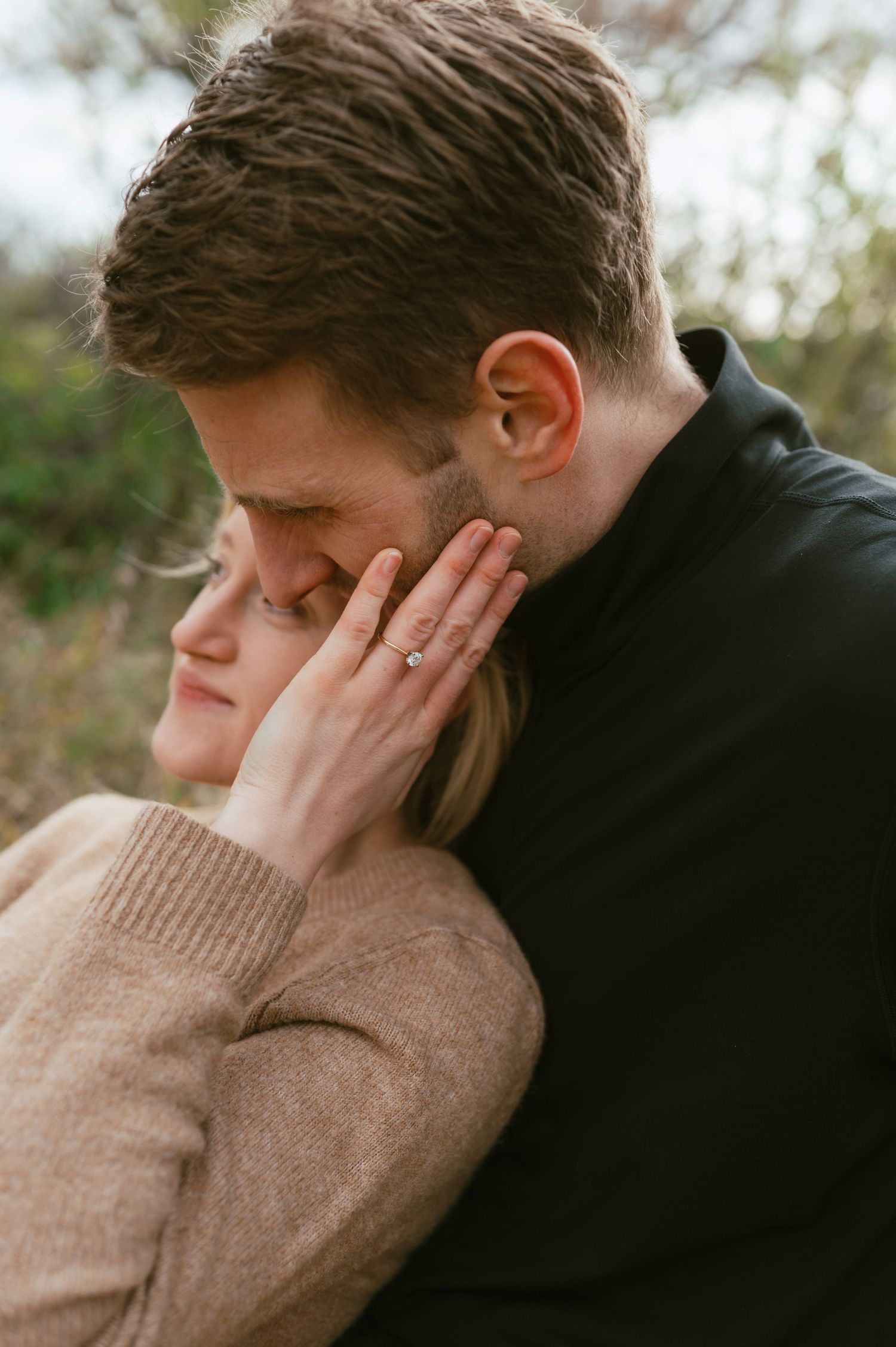 Intimate moment between couple in autumn wearing cozy sweaters.