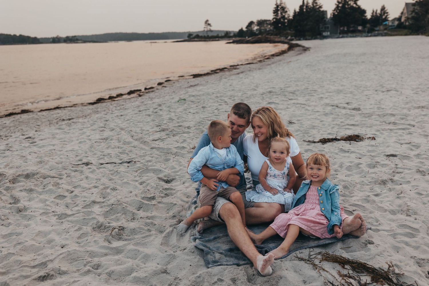 Family moments captured on a sandy beach at sunset.