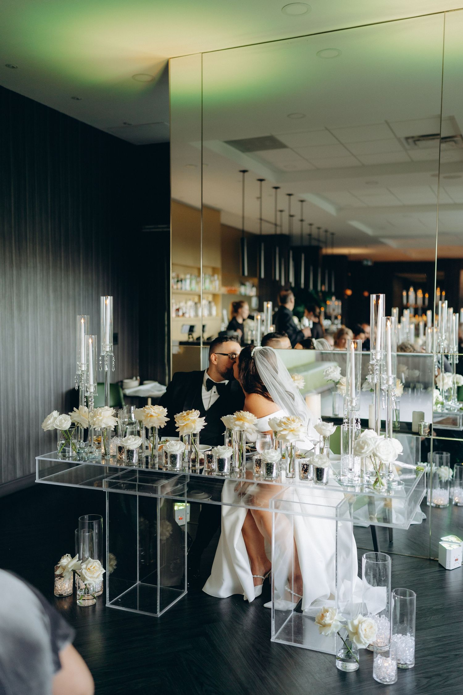 Luxurious wedding setup with crystal chandeliers and floral decorations in an intimate setting.