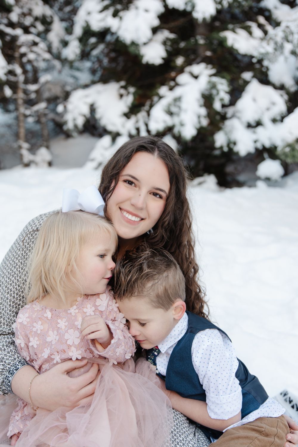 An intimate family moment captured against a snowy winter background.