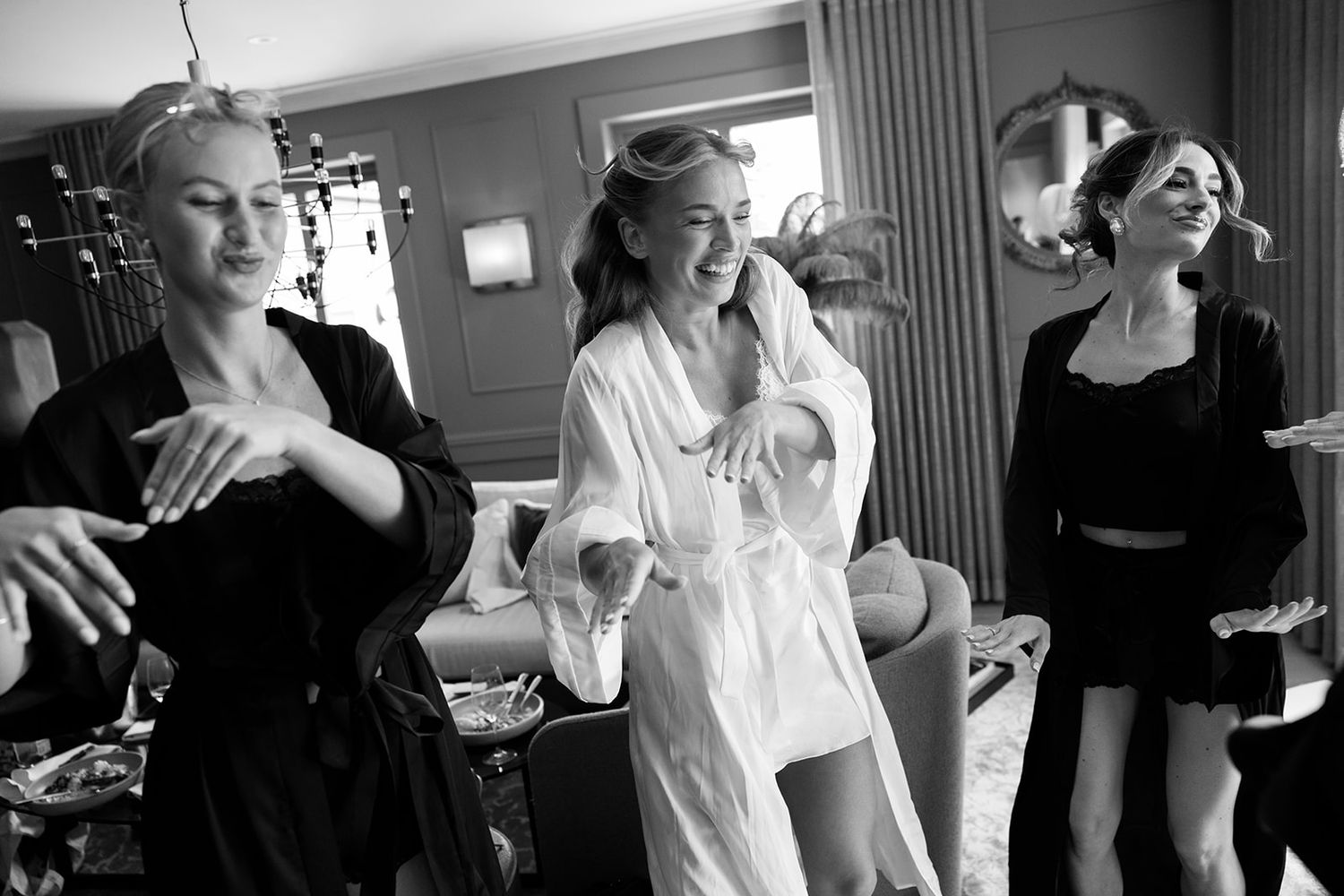 Black and white photo strip showing candid moments of people laughing and interacting in casual social settings.