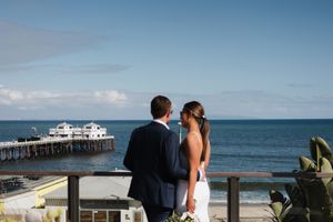 Oceanfront wedding ceremony setting with blue sky and water in the background.